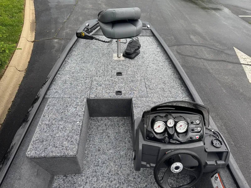 Slide: The Image of 2025 Tracker Pro 170 boat interior with steering console and seating. - 2