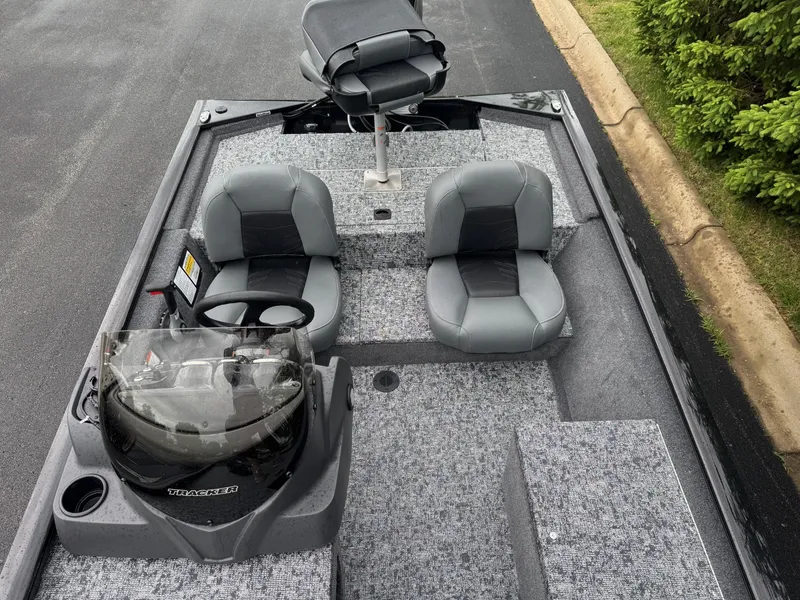 Slide: The Image of 2025 Tracker Pro 170 boat interior with gray seating and steering console. - 3