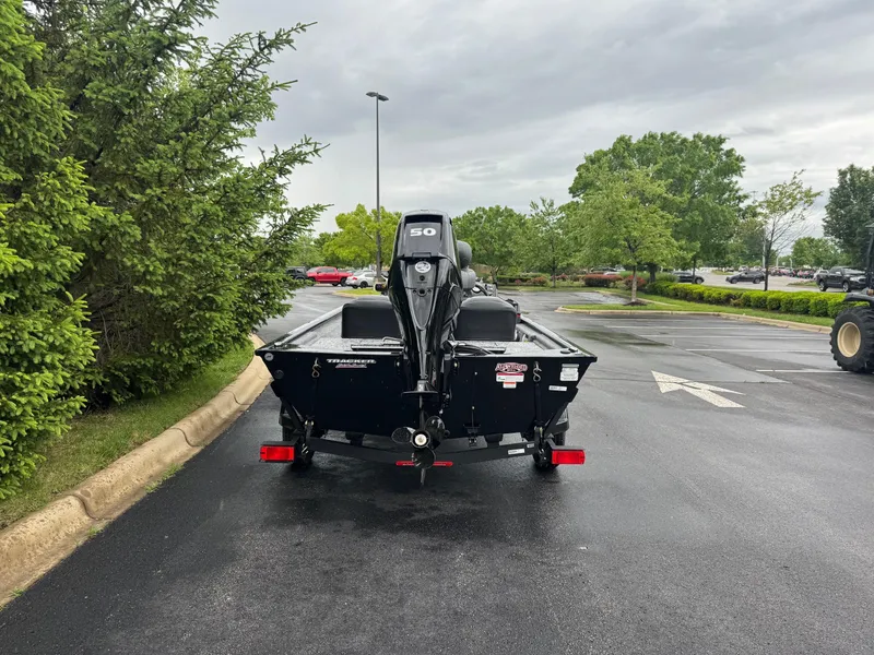 Slide: The Image of 2025 Tracker Pro 170 boat on trailer in parking lot, surrounded by greenery. - 4