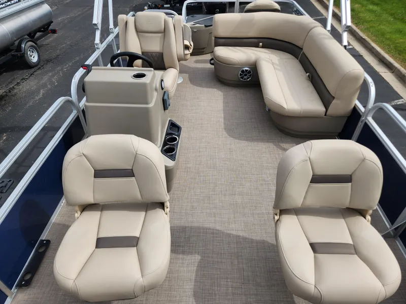 Slide: The Image of 2025 Sun Tracker Bass Buggy 18 DLX pontoon boat with beige seating and spacious layout. - 2