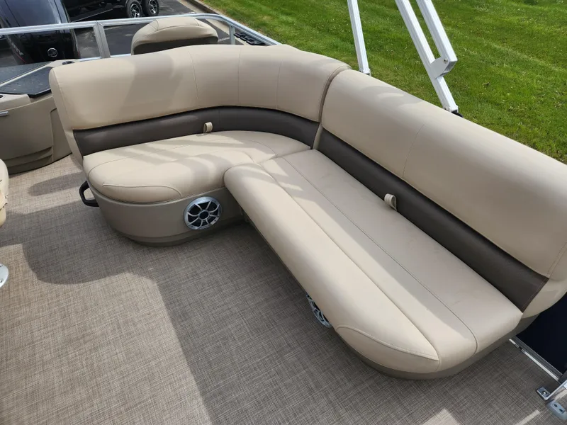Slide: The Image of 2025 Sun Tracker Bass Buggy 18 DLX pontoon boat with beige seating and speaker system. - 5