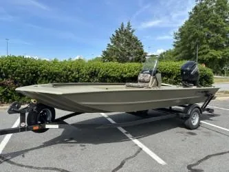 Slide: The Image of 2025 Tracker Grizzly 1860 CC boat on trailer in parking lot. - 2