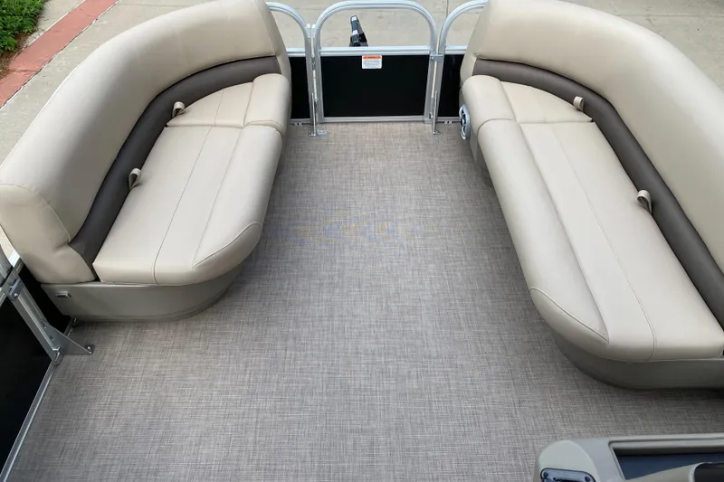 Slide: The Image of 2025 Sun Tracker Party Barge 16 DLX interior with beige seating and spacious deck. - 3
