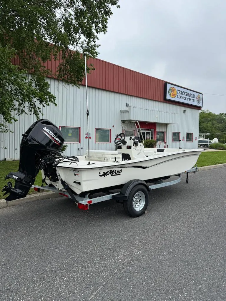 Slide: The Image of 2025 Mako Pro Skiff 15 CC boat on trailer outside service center. - 4
