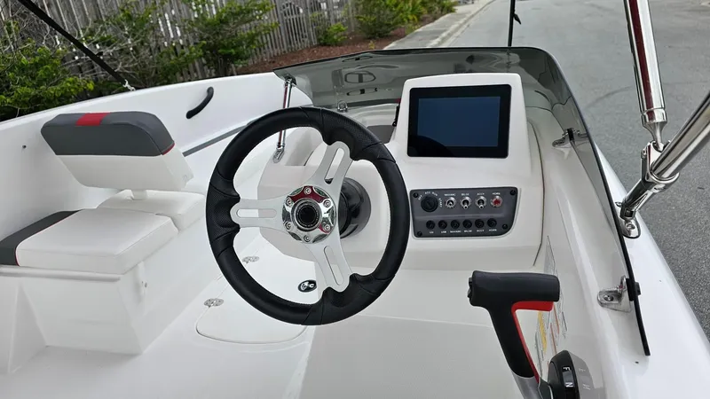 Slide: The Image of 2025 Tahoe T16 boat cockpit with steering wheel and control panel. - 7