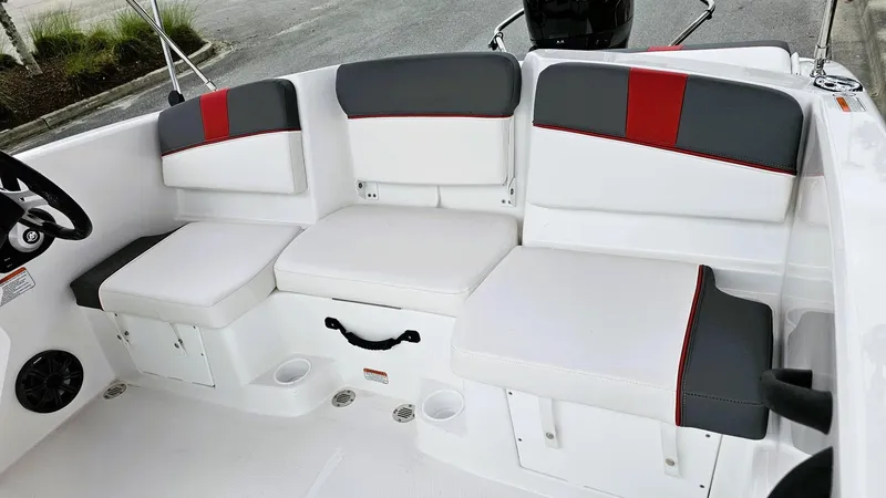 Slide: The Image of 2025 Tahoe T16 boat interior with white and gray seating, red accents, and storage compartments. - 9