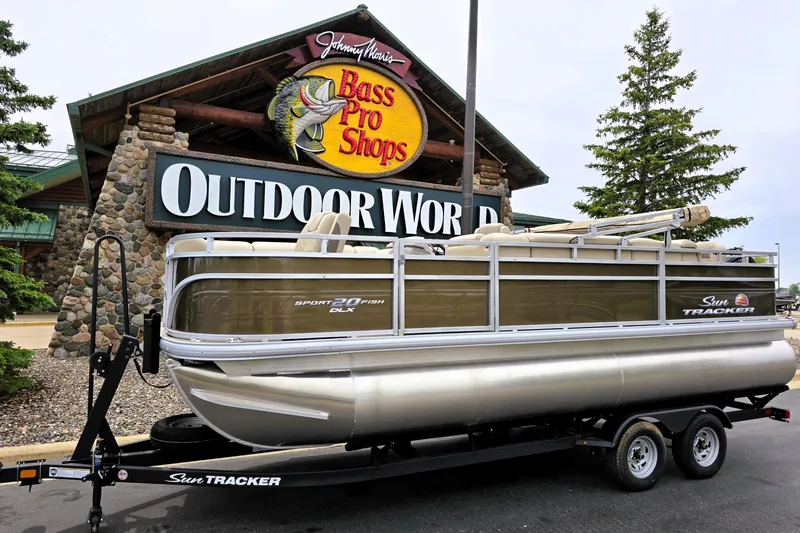 The Image of 2025 Sun Tracker SportFish 20 DLX pontoon boat on trailer at Bass Pro Shops. - 0