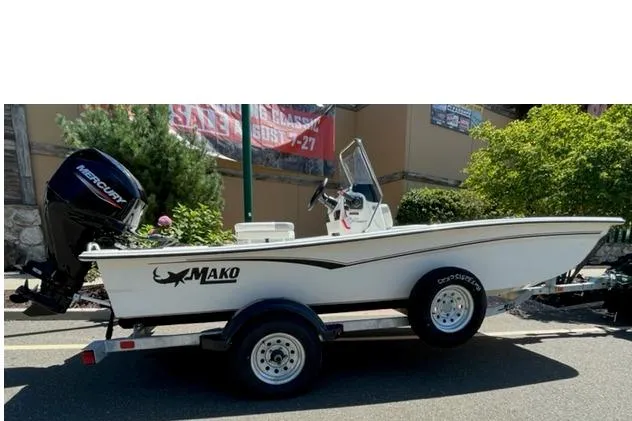 The Image of 2025 Mako Pro Skiff 15 CC boat on trailer, featuring Mercury outboard motor. - 0