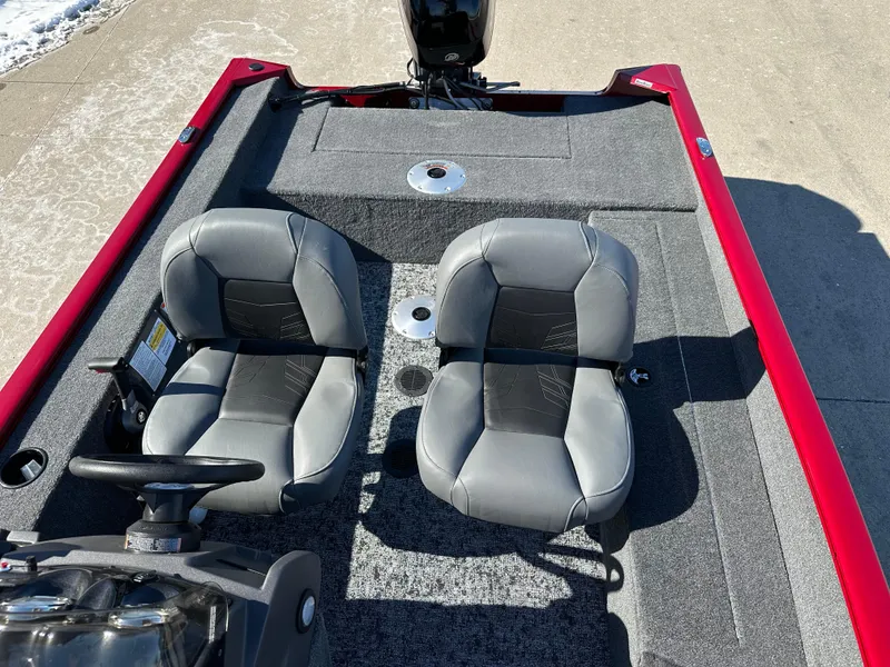 Slide: The Image of 2025 Tracker Super Guide V-16 SC boat interior with two gray seats and red trim. - 6
