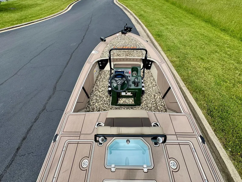 Slide: The Image of 2025 Mako 18 Pro Skiff Backwater Edition on road, showcasing interior and steering console. - 4