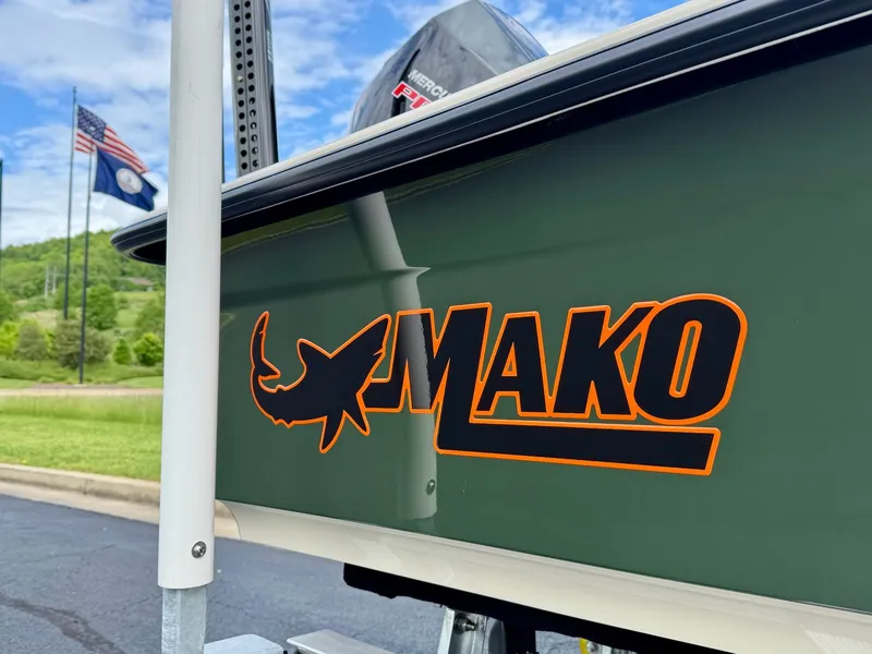 Slide: The Image of 2025 Mako 18 Pro Skiff Backwater Edition boat with logo, flags, and scenic background. - 9