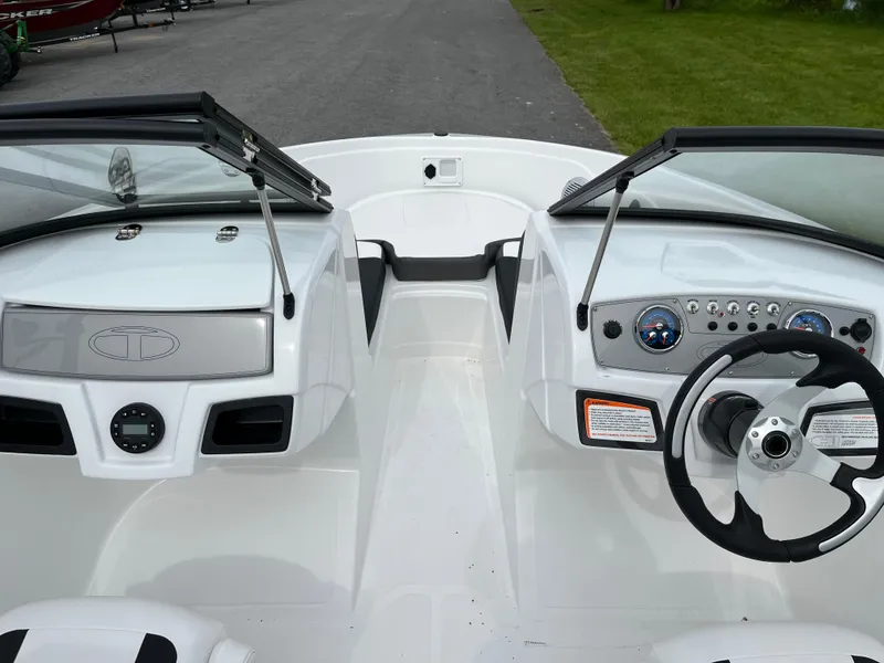 Slide: The Image of 2025 Tahoe 185 S boat interior with dual consoles and steering wheel. - 2