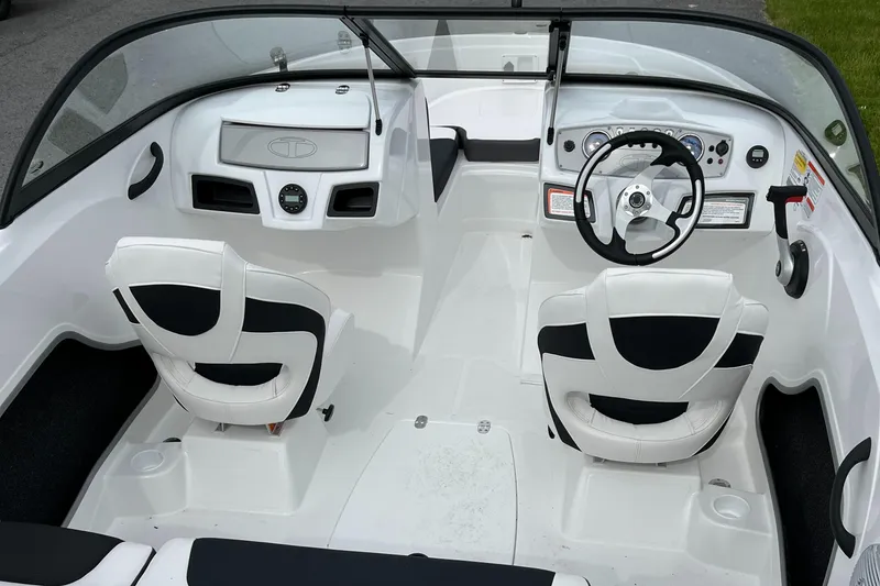 Slide: The Image of 2025 Tahoe 185 S boat interior with white seating and modern dashboard design. - 3