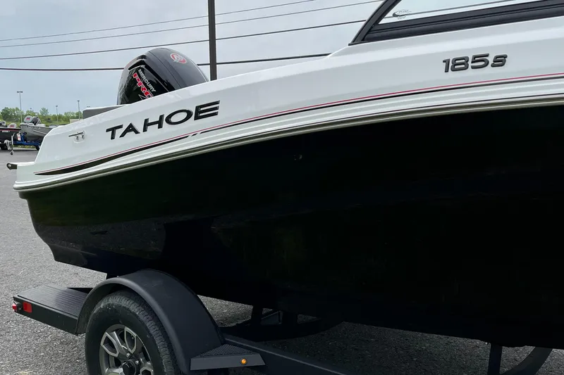 Slide: The Image of 2025 Tahoe 185 S boat on trailer, black and white design, side view. - 6