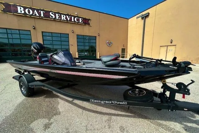 Slide: The Image of 2025 Ranger RT178 boat on trailer outside boat service center. - 0