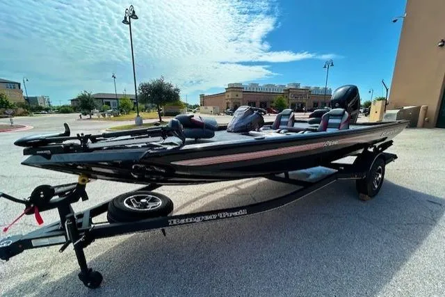 Slide: The Image of 2025 Ranger RT178 fishing boat on trailer, parked outdoors under a clear sky. - 1