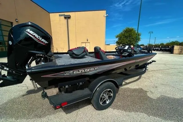 Slide: The Image of 2025 Ranger RT178 boat with Mercury engine, parked outdoors on a sunny day. - 2