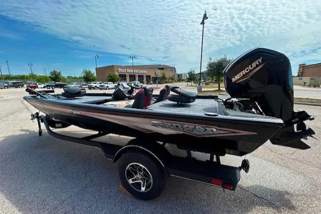 Slide: The Image of 2025 Ranger RT178 boat with Mercury engine in a parking lot under a cloudy sky. - 3