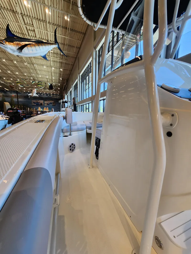 Slide: The Image of 2025 Mako 214 CC boat interior with sleek design in showroom. - 6