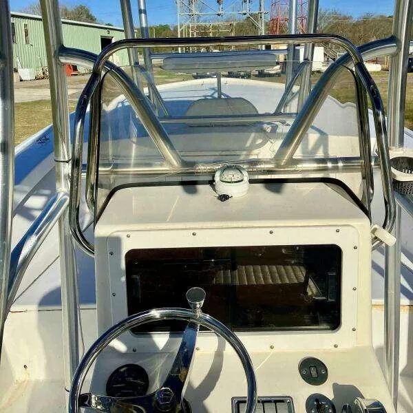 Slide: The Image of Custom 24 OPEN 1995 boat cockpit with steering wheel and navigation instruments. - 15