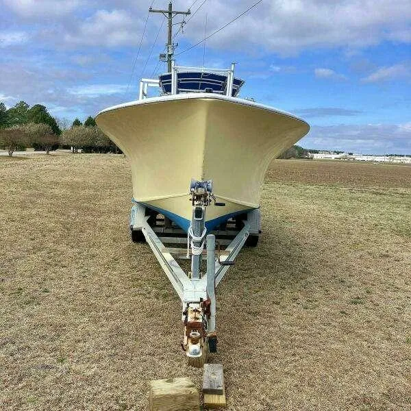 Slide: The Image of Front view of a 1995 Custom 24 OPEN boat on a trailer in a grassy field. - 5