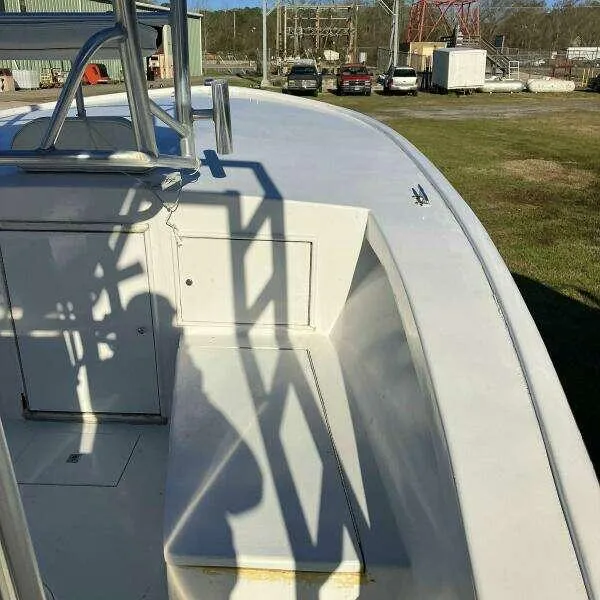 Slide: The Image of 1995 Custom 24 OPEN boat deck with shadows, parked outdoors. - 8
