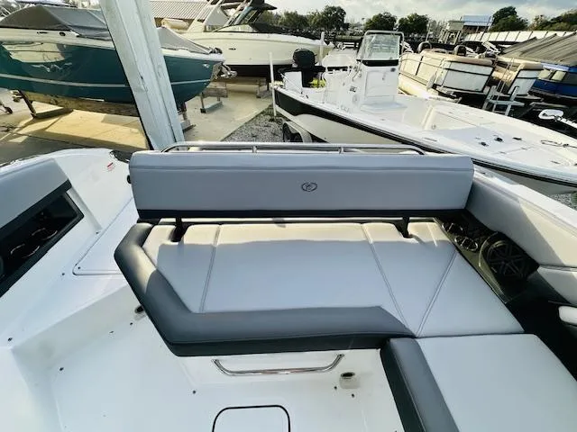 Slide: The Image of 2022 Cobalt R8 boat interior with sleek seating at a marina. - 10