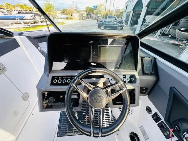 Slide: The Image of 2022 Cobalt R8 boat dashboard with steering wheel and digital displays. - 15