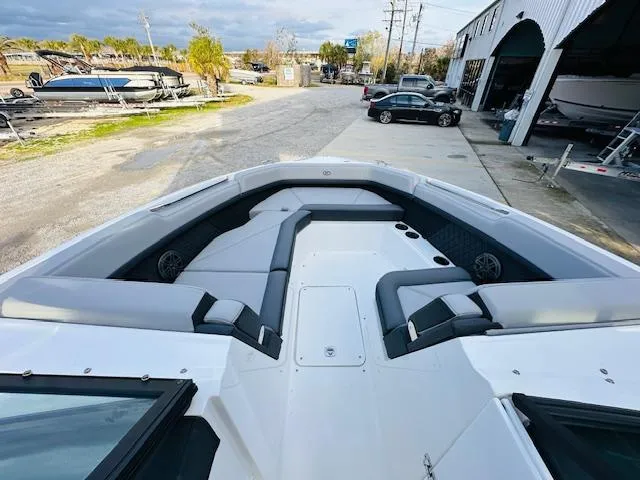 Slide: The Image of 2022 Cobalt R8 boat with spacious seating, docked near a marina. - 17