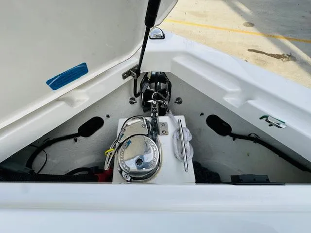 Slide: The Image of 2022 Cobalt R8 boat anchor compartment with open hatch, showcasing anchor and winch system. - 20