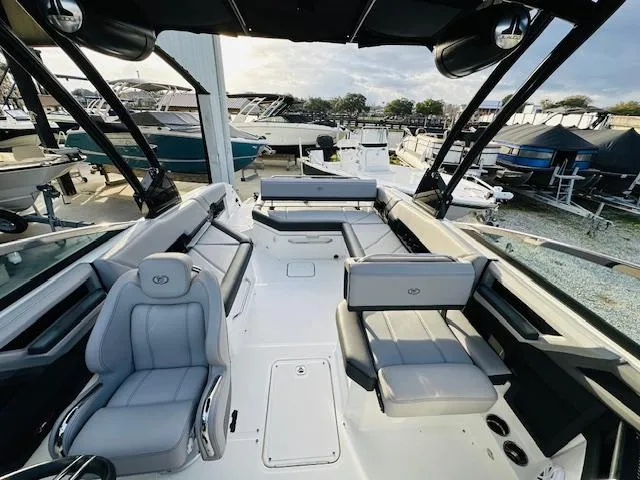 Slide: The Image of 2022 Cobalt R8 boat interior with gray seating, docked among other boats. - 25