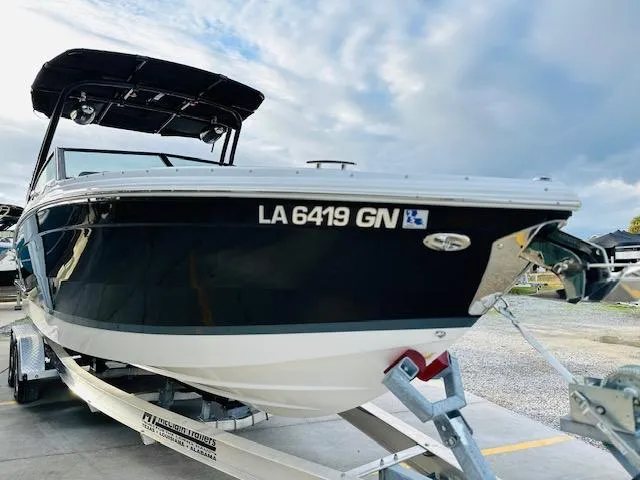 Slide: The Image of 2022 Cobalt R8 boat on trailer, black hull, overcast sky background. - 7