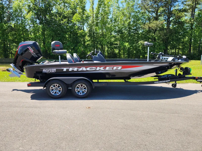 The Image of 2025 Tracker Savage 215 boat on trailer, parked on road with forest background. - 0