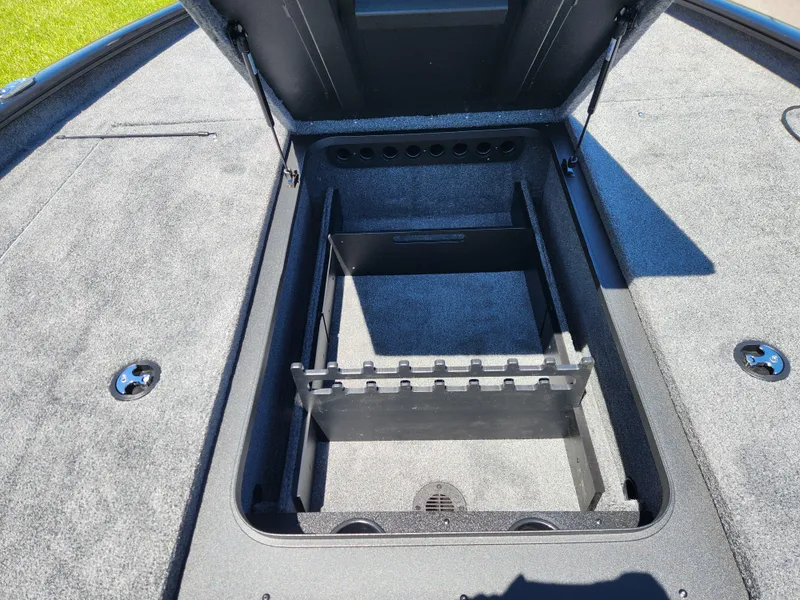 Slide: The Image of 2025 Tracker Savage 215 boat storage compartment with open lid, showcasing interior design. - 14