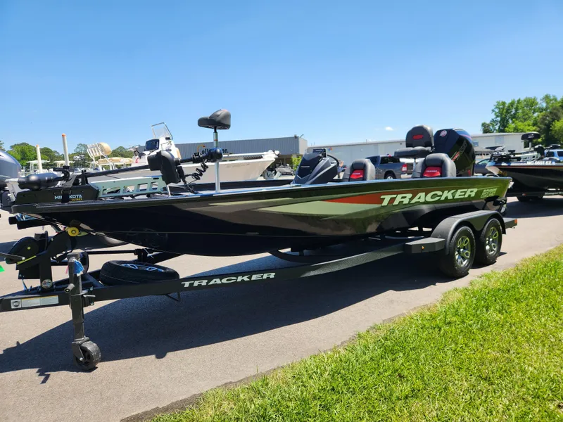 Slide: The Image of 2025 Tracker Savage 215 boat on trailer, parked on sunny day, showcasing sleek design. - 8