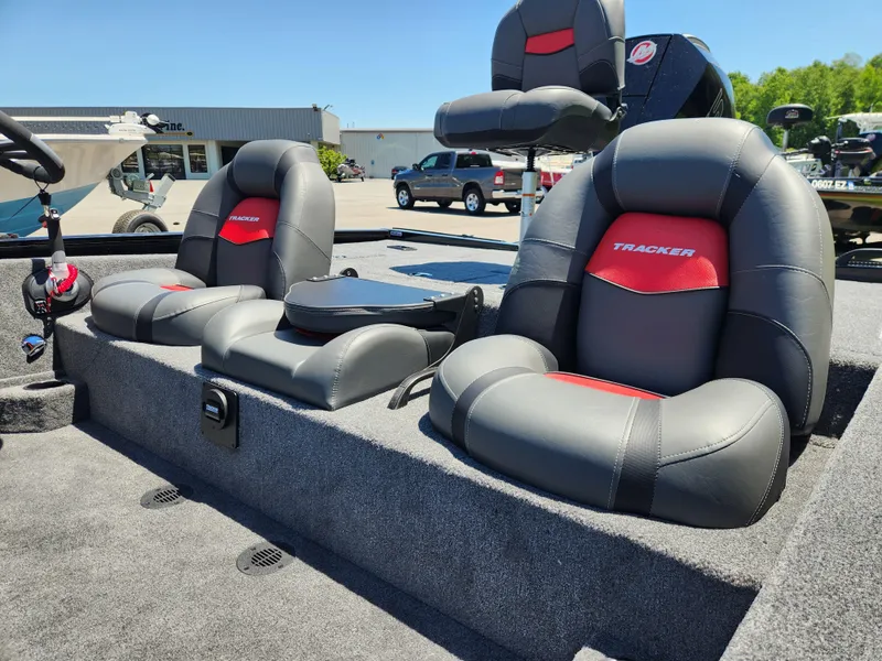 Slide: The Image of 2025 Tracker Savage 215 boat interior with gray and red cushioned seats. - 9
