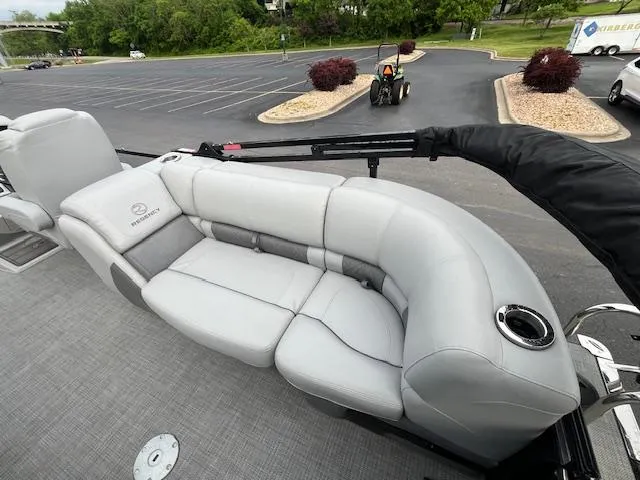 Slide: The Image of 2024 Regency 250LE3 boat with luxurious gray seating in a parking lot. - 12