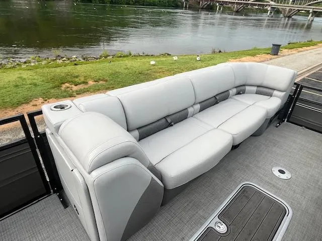Slide: The Image of 2024 Regency 250LE3 pontoon boat with spacious seating by the river. - 13