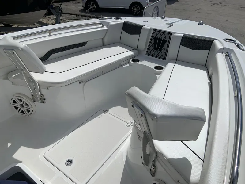 Slide: The Image of 2020 Wellcraft 222F boat interior with white seating and storage compartments. - 12