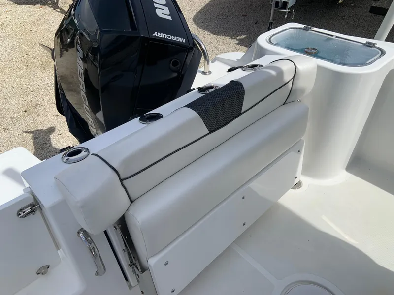 Slide: The Image of 2020 Wellcraft 222F boat interior with seating and Mercury engine. - 5