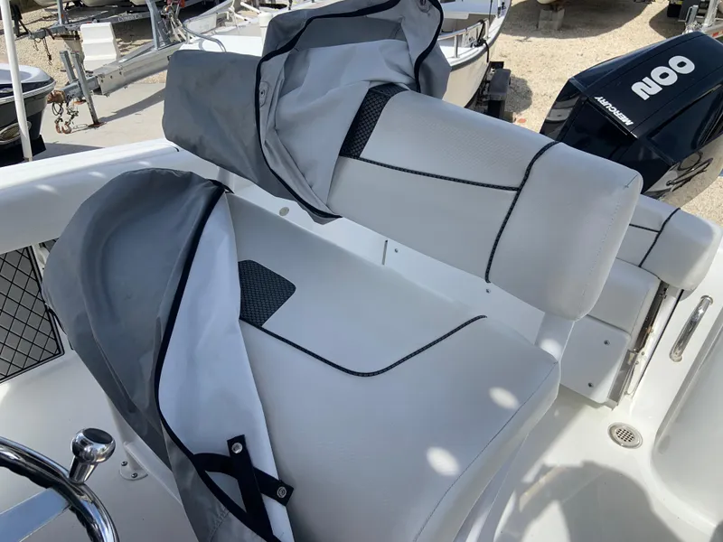 Slide: The Image of 2020 Wellcraft 222F boat seats with protective covers, showcasing sleek design and comfort. - 8