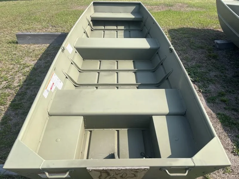 Slide: The Image of 2024 Lowe 1240 boat, green aluminum hull, parked on grass. - 4