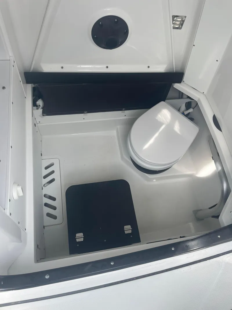 Slide: The Image of 2022 Blackfin 272 CC boat interior with compact marine toilet. - 10