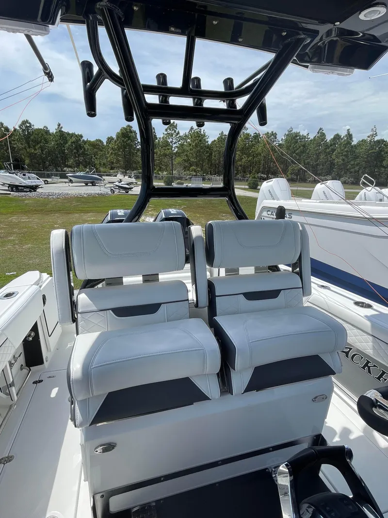 Slide: The Image of 2022 Blackfin 272 CC boat with dual white seats and sturdy black frame. - 7