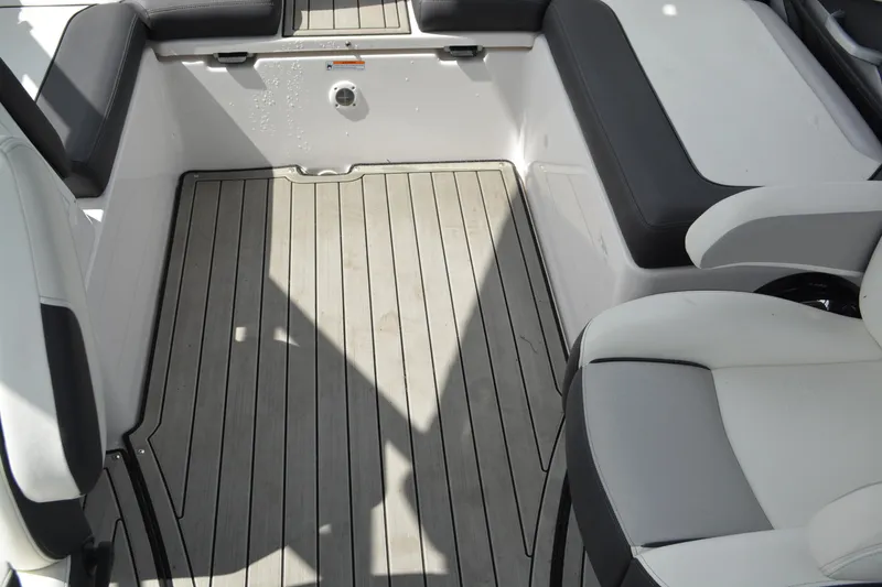 Slide: The Image of 2021 Yamaha Boats 252SD interior with sleek seating and modern flooring design. - 15