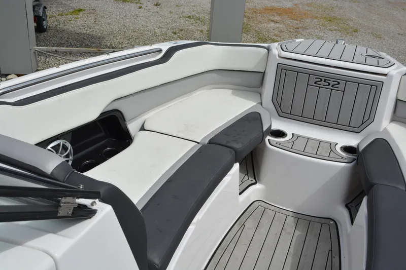 Slide: The Image of 2021 Yamaha Boats 252SD interior with seating and cup holders, featuring sleek design and modern amenities. - 16