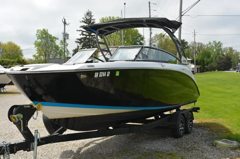 Slide: The Image of 2021 Yamaha Boats 252SD on trailer, black hull, parked outdoors. - 3