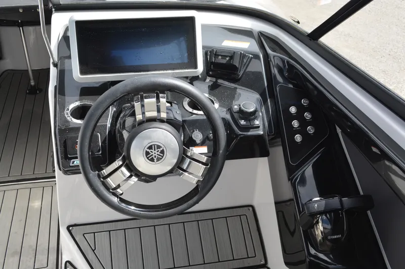 Slide: The Image of 2021 Yamaha Boats 252SD dashboard with steering wheel and digital display. - 9