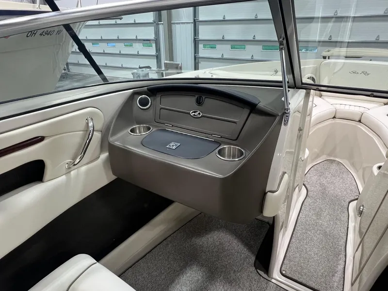 Slide: The Image of 2008 Sea Ray 230 Select boat interior with seating, cup holders, and storage compartment. - 13