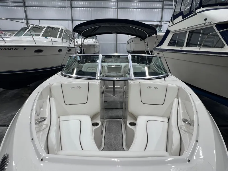 Slide: The Image of 2008 Sea Ray 230 Select boat with white interior, docked in a storage facility. - 16